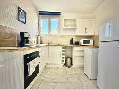 a living room with a glass table and chairs at Centre Carcassonne apartment with private sunny terrace in Carcassonne