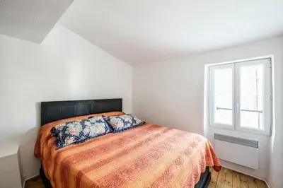 a bedroom with a bed and a window at Maison atypique dans circulade in Bram
