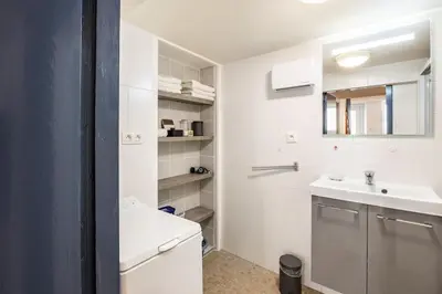 a white bathroom with a sink and a toilet at Maison atypique dans circulade in Bram