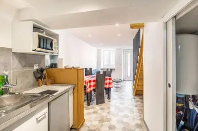 a kitchen with a table and a dining room at Maison atypique dans circulade in Bram