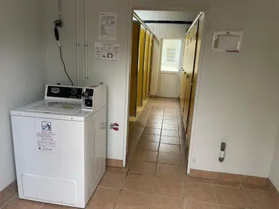 a hallway with a washer and dryer in a room at Flower Camping La Pibola in Camon