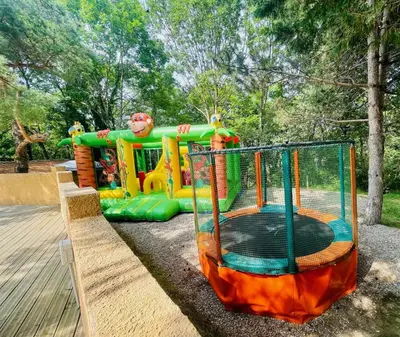a playground with a play equipment in a park at Flower Camping La Pibola in Camon