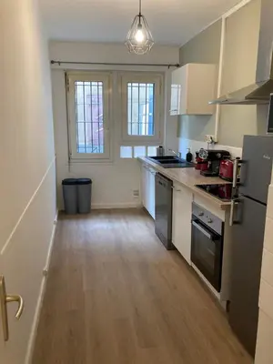 a kitchen with a sink and a stove at CARC'APPART Appartements à Carcassonne in Carcassonne