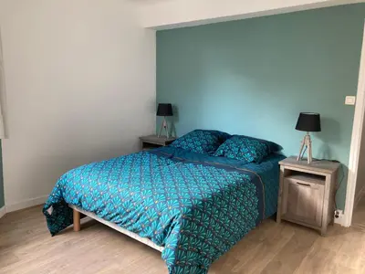 a bedroom with a bed and two lamps on a night stand at CARC'APPART Appartements à Carcassonne in Carcassonne