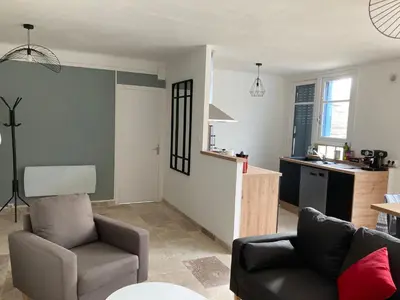 a living room with a couch and a chair at CARC'APPART Appartements à Carcassonne in Carcassonne