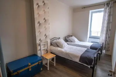 a bedroom with two beds and a window at Charme au cœur des vignes in Malras
