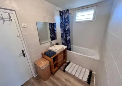 a small bathroom with a sink and a mirror at Le Cosy in Narbonne