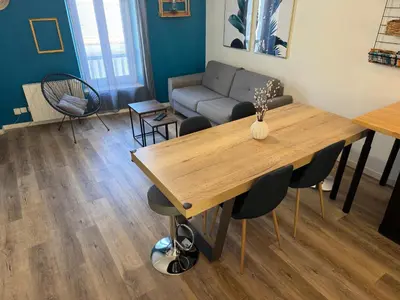 a living room with a table and a couch at Le Cosy in Narbonne