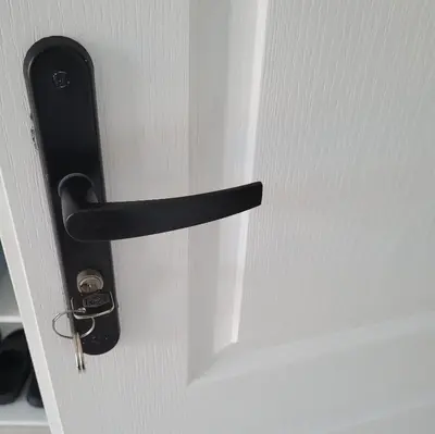 a black door handle on a white door at B&B BonjourSoleil in Tourouzelle