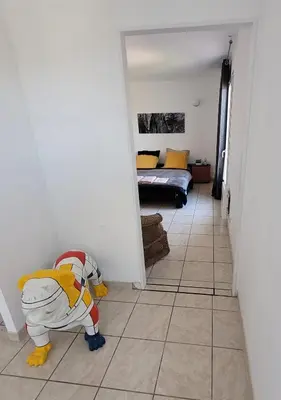 a toy dog is standing on the floor in a hallway at B&B BonjourSoleil in Tourouzelle