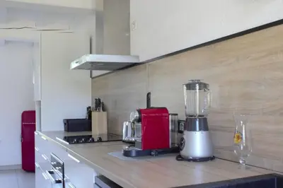 a kitchen with a blender on a counter at DOMAINE LA MASQUIERETTE in Villepinte