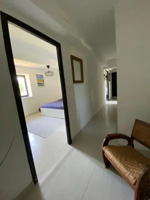 a mirror in a room with a couch and a bed at DOMAINE LA MASQUIERETTE in Villepinte