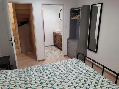 a bedroom with a bed and a bathroom at maison des vendangeurs in Villarzel-Cabardès