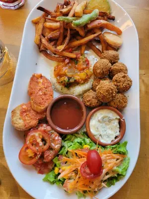 a white plate of food with french fries and dips at Le sapin rouge - Restaurant - bar - chambres d'hôtes in Artigues