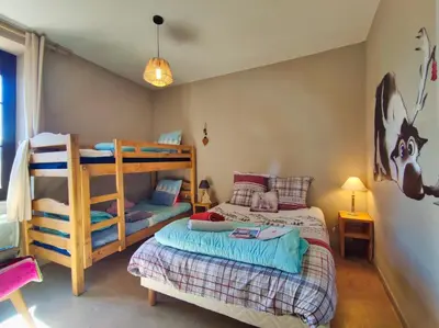 a bedroom with two bunk beds and a bed at Le sapin rouge - Restaurant - bar - chambres d'hôtes in Artigues