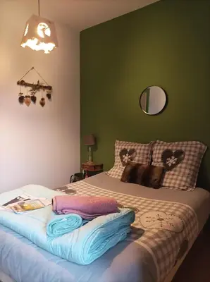a bedroom with a bed with towels on it at Le sapin rouge - Restaurant - bar - chambres d'hôtes in Artigues