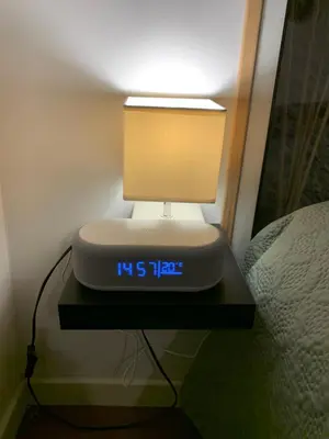a clock on a table with a light on it at La Roche - Studio 2 étoiles Eco Responsable avec Tv Connectée in Maury