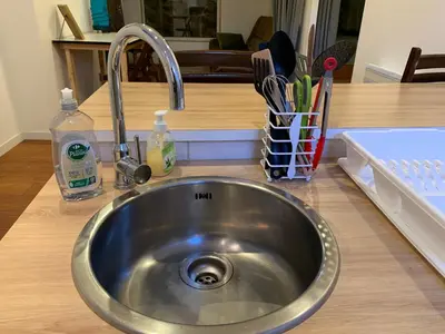 a stainless steel sink in a kitchen with utensils at La Roche - Studio 2 étoiles Eco Responsable avec Tv Connectée in Maury