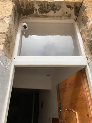 a building that is being remodeled with a door at La Roche - Studio 2 étoiles Eco Responsable avec Tv Connectée in Maury