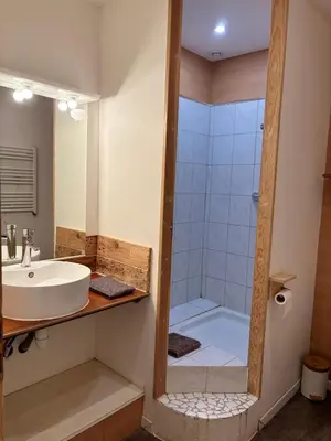 a bathroom with a sink and a shower at La Roche - Studio 2 étoiles Eco Responsable avec Tv Connectée in Maury