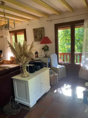 a living room with a couch and a table at Chalet de charme in Montfort-sur-Boulzane