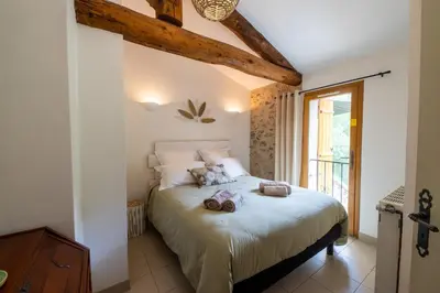 a bedroom with a bed with two towels on it at La Mazette, les pieds dans l'eau ! Privatisée ! 16 Pers in Olargues