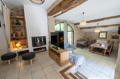 a living room with a couch and a tv at La Mazette, les pieds dans l'eau ! Privatisée ! 16 Pers in Olargues