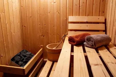 a sauna with two towels sitting on a wooden table at La Mazette, les pieds dans l'eau ! Privatisée ! 16 Pers in Olargues