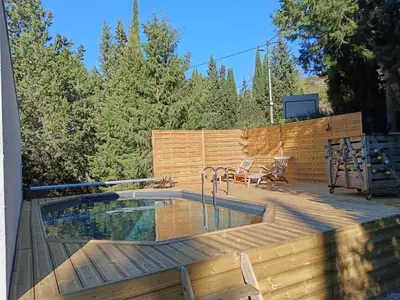 a deck with a swimming pool on top of a house at Magnifique villa avec piscine, jacuzzi et billard in Limoux