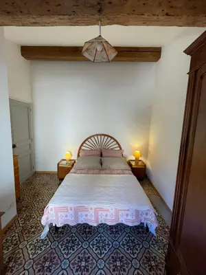 a bedroom with a large bed in a room at appartement chez l'artiste in Minerve