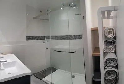 a glass shower in a bathroom with a sink at Gîte avec Piscine Proche de Carcassonne in Couffoulens