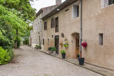 an empty street in an old building with potted plants at Gîte - Holiday Home Vent Autan in Limoux
