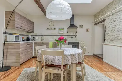 a kitchen with a table with a vase of flowers on it at Gîte - Holiday Home Vent Autan in Limoux