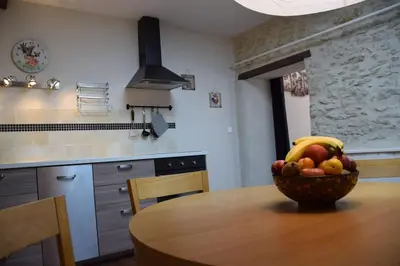 a bowl of fruit on a wooden table in a kitchen at Gîte - Holiday Home Vent Autan in Limoux