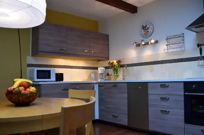 a kitchen with a table with a bowl of fruit on it at Gîte - Holiday Home Vent Autan in Limoux