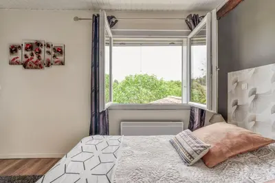 a bedroom with a bed and a large window at Gîte - Holiday Home Vent Autan in Limoux