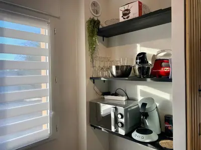 a kitchen with a coffee maker on a shelf at L'alcôve - T2 Calme, Terrasse & Parking privé in Castres