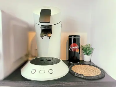 a white mixer sitting on a counter next to a bottle of wine at L'alcôve - T2 Calme, Terrasse & Parking privé in Castres
