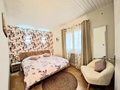a bedroom with a bed and a chair at Maison Richelieu in Bram