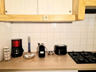a kitchen counter with a coffee maker and a toaster at Maison Richelieu in Bram