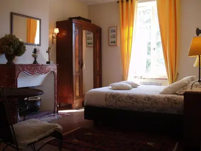 a bedroom with a bed and a window at La Cerisaie - Chambres d'hôtes & gites in Riols
