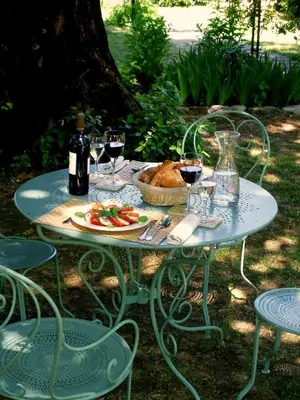 a table with a plate of food and glasses of wine at La Cerisaie - Chambres d'hôtes & gites in Riols