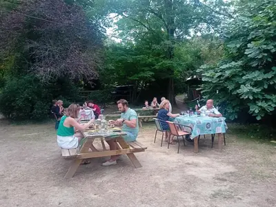 a group of people sitting at a picnic table at Domaine La Sauzette in Palaja