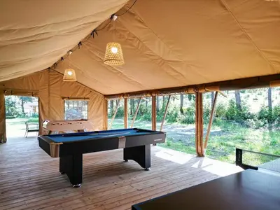 a room with a pool table in a tent at Domaine La Sauzette in Palaja