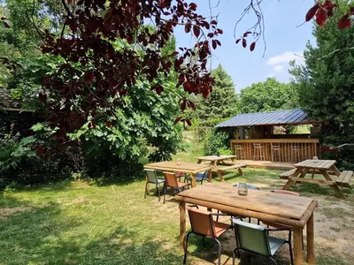 a group of picnic tables in the grass at Domaine La Sauzette in Palaja