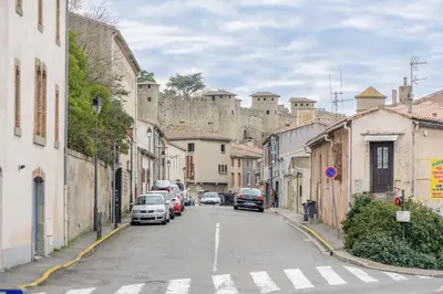 a city street with a castle in the background at Romantique Duplex au pied de la cité in Carcassonne