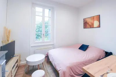 a small bedroom with a bed and a window at Romantique Duplex au pied de la cité in Carcassonne