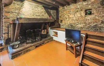 a living room with a fireplace and a tv at Cozy Home In Olargues With Kitchen in Olargues