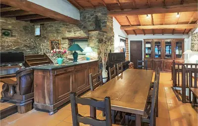 a dining room with a wooden table and chairs at Cozy Home In Olargues With Kitchen in Olargues