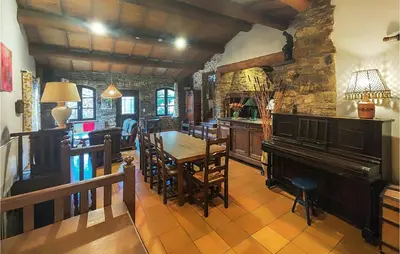 a dining room with a table and a piano at Cozy Home In Olargues With Kitchen in Olargues